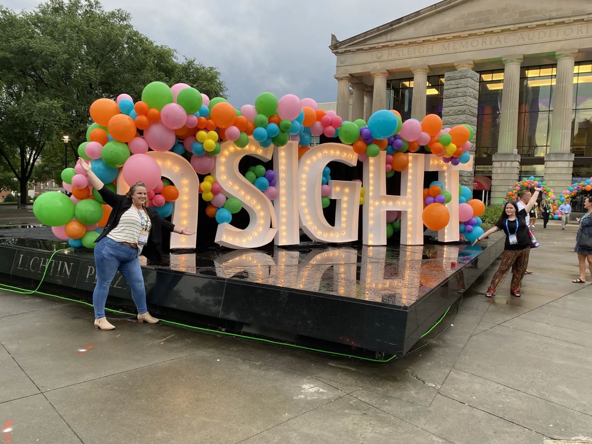 Two women with a nSight sign.