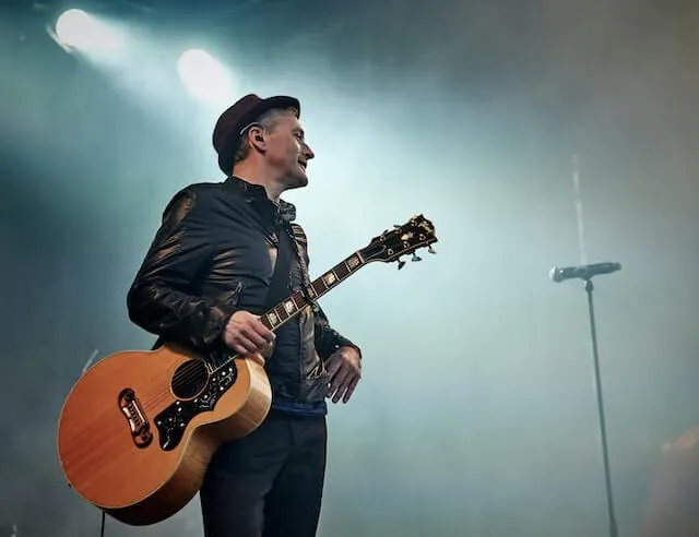 man with guitar at the concert