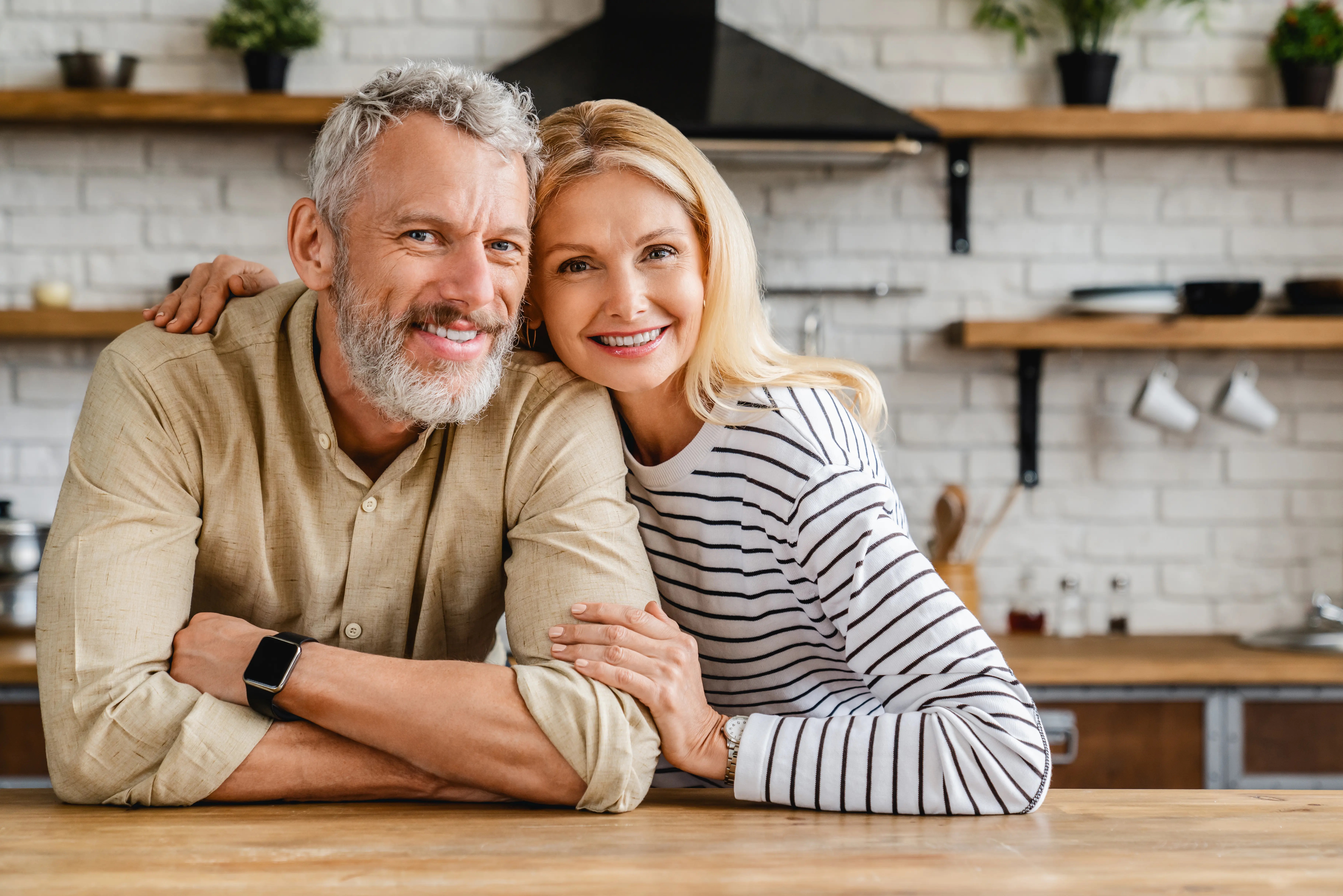 A man and a woman are posing for a picture.
