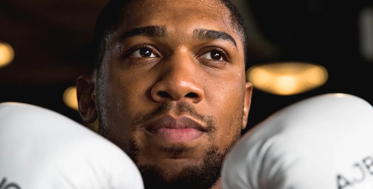 Detailed close-up portrait of Anthony Joshua showing sweat texture and post-workout intensity