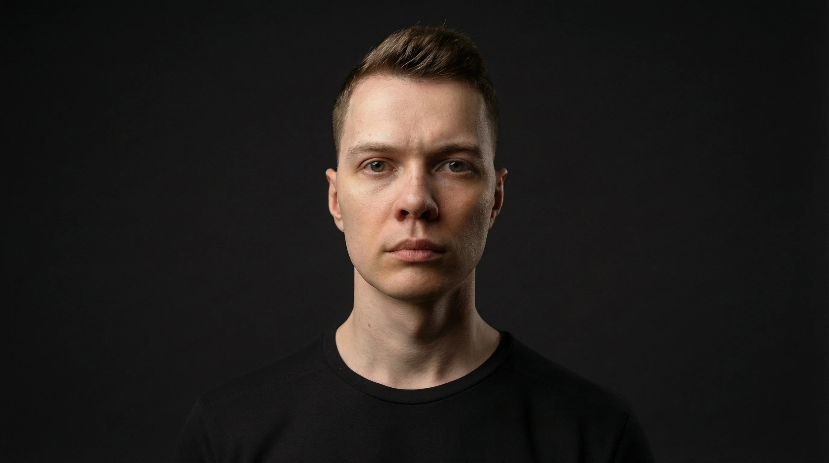 Professional studio portrait of Andrew Kersis, Brand & Webflow Designer