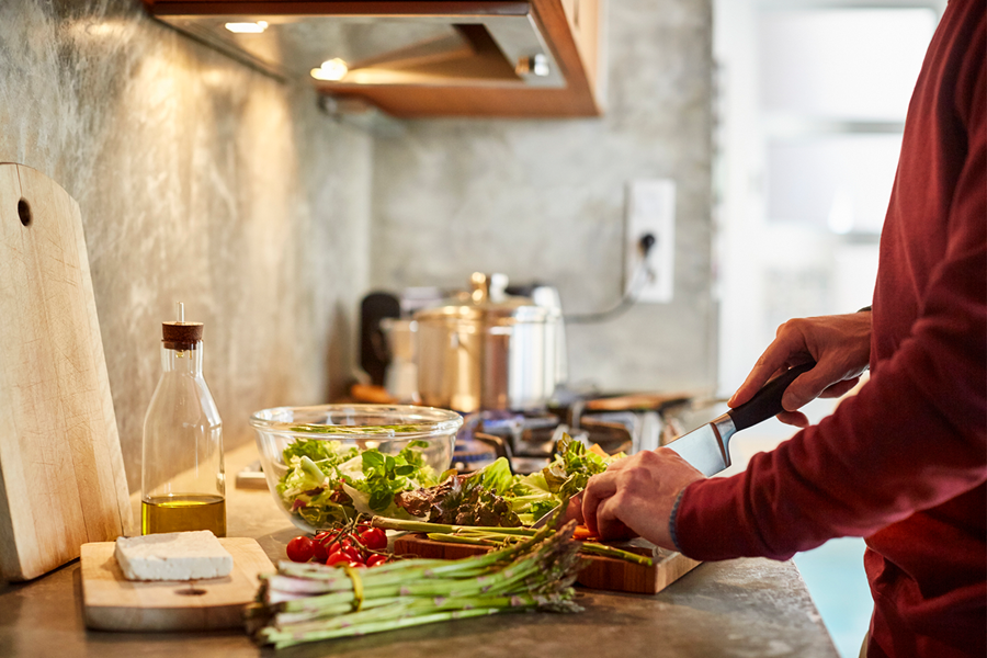 A person preparing dinner at their counter