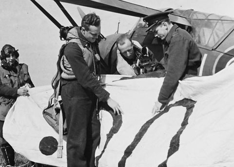 An air ministry photo showing a pupil examining his shooting results