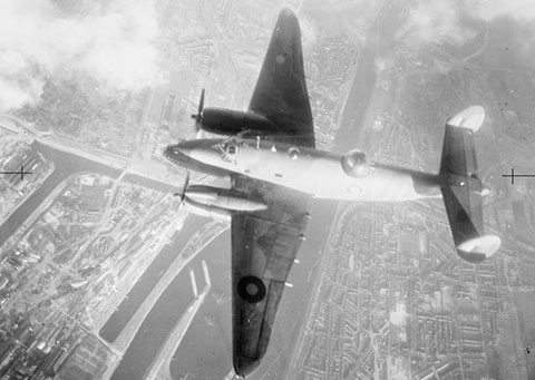 Lockheed Ventura of No. 21 Squadron over the docks at Ijmuiden, Holland, during the second of two daylight attacks, on the coke ovens of the Royal Dutch Steel Works, 13 February 1943.