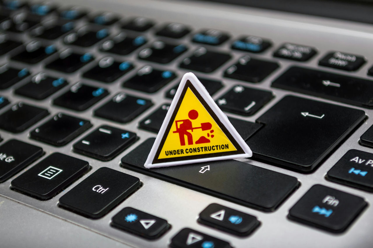 Under construction warning sign on a laptop keyboard