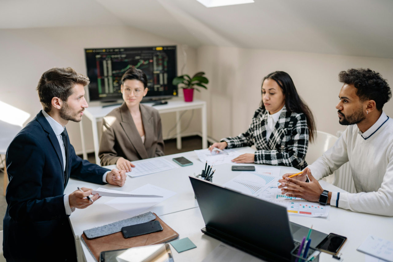 Business team analyzing financial data in modern office meeting
