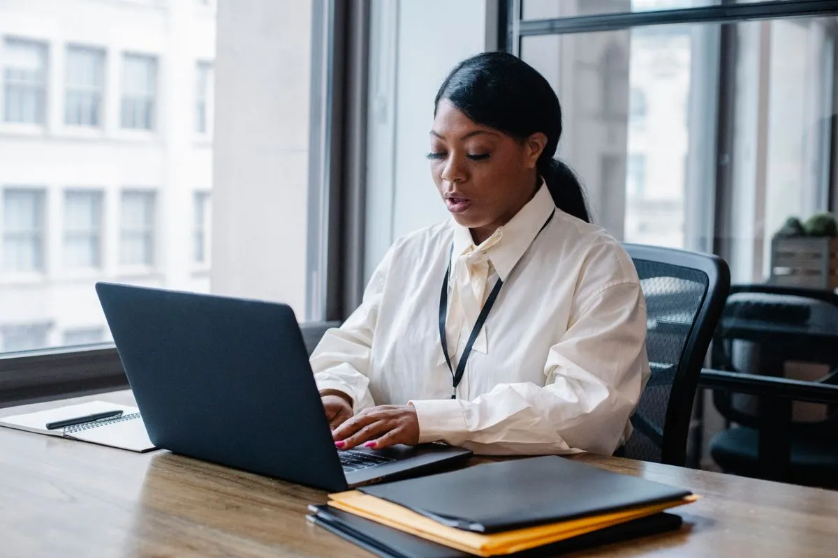 HR professional working at a laptop