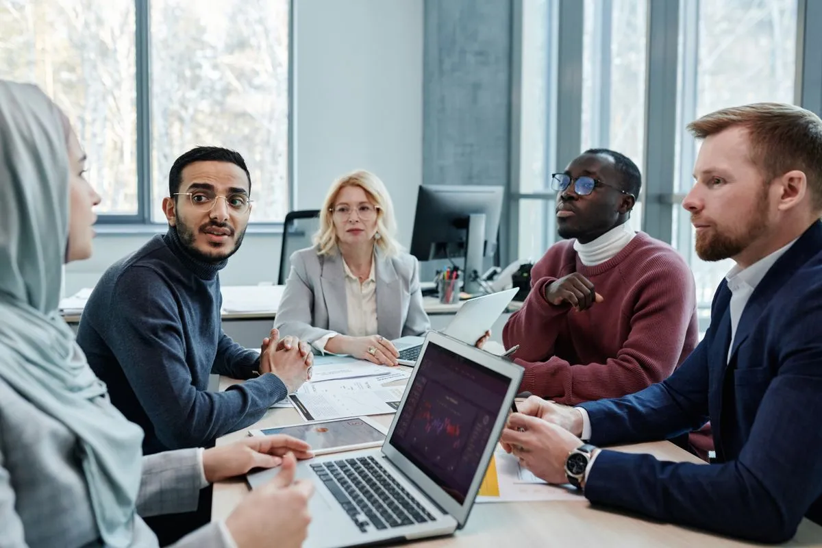 Talent acquisition team meeting around a table