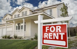 A for rent sign in front of a house.
