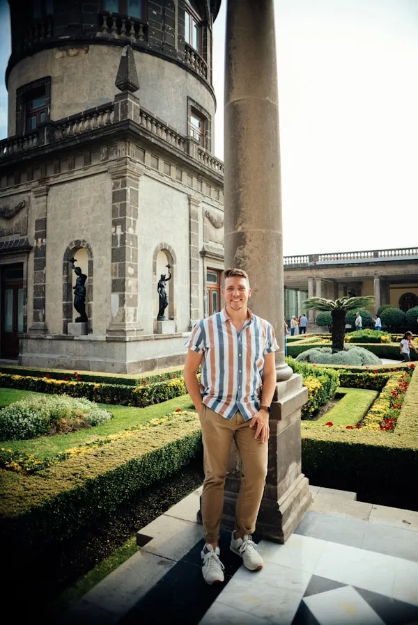 a man standing in front of a tall building