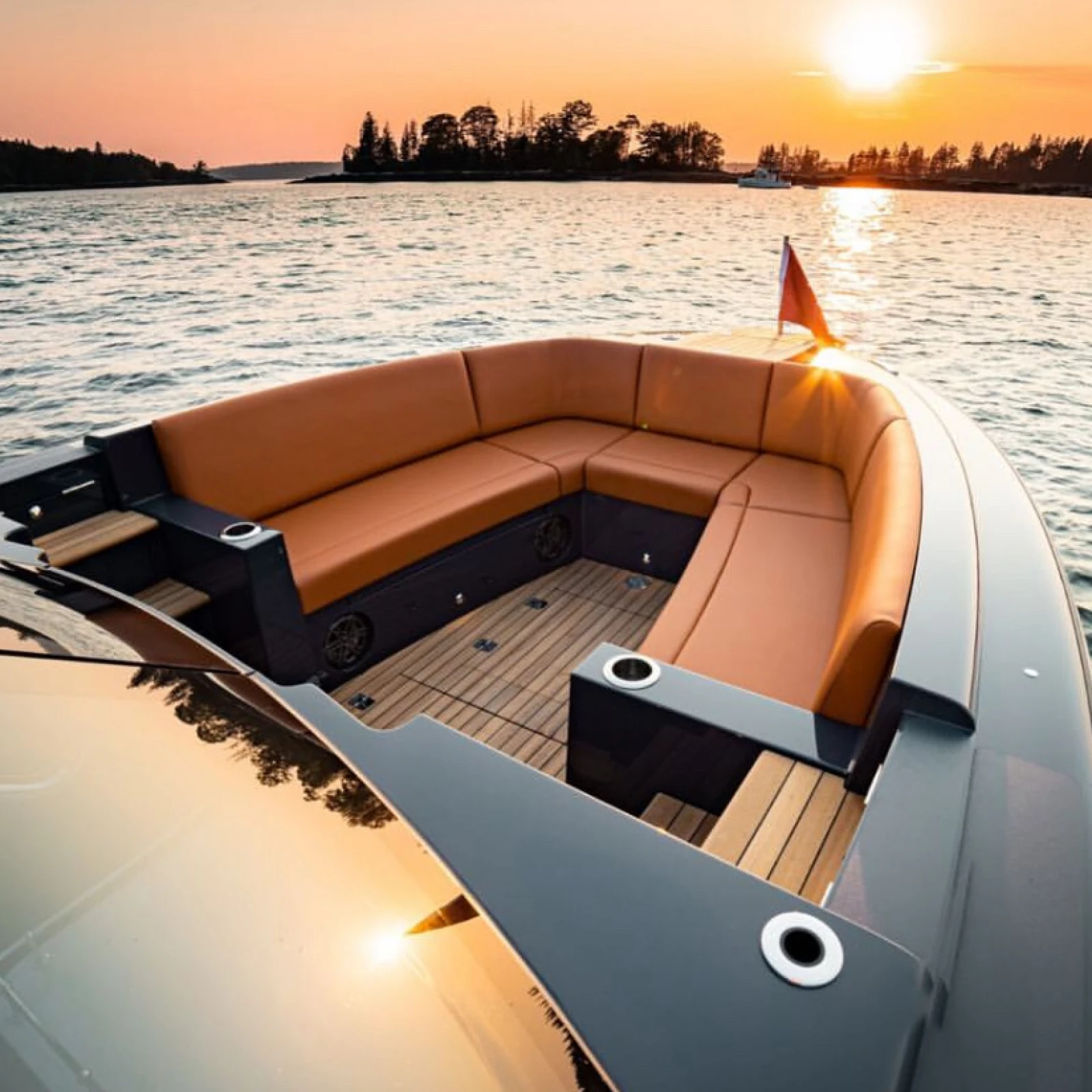 Sunset view of a luxury boat’s bow lounge with custom marine upholstery by Alfred’s Maine, featuring handcrafted seating and elegant design.