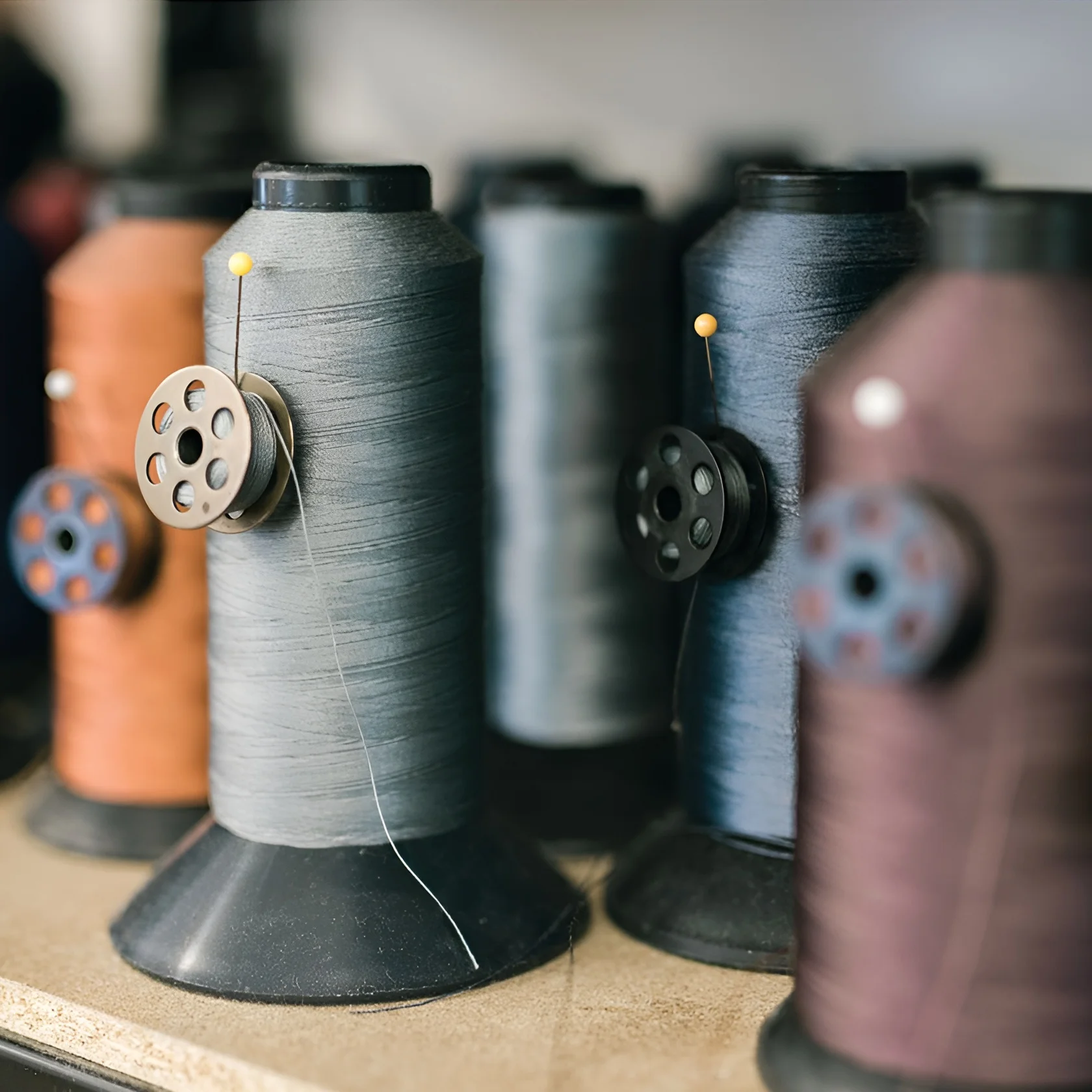 Thread spools in Alfred’s upholstery workshop, representing the start of the bespoke upholstery and custom furniture creation process with expert craftsmanship and luxury design intent.