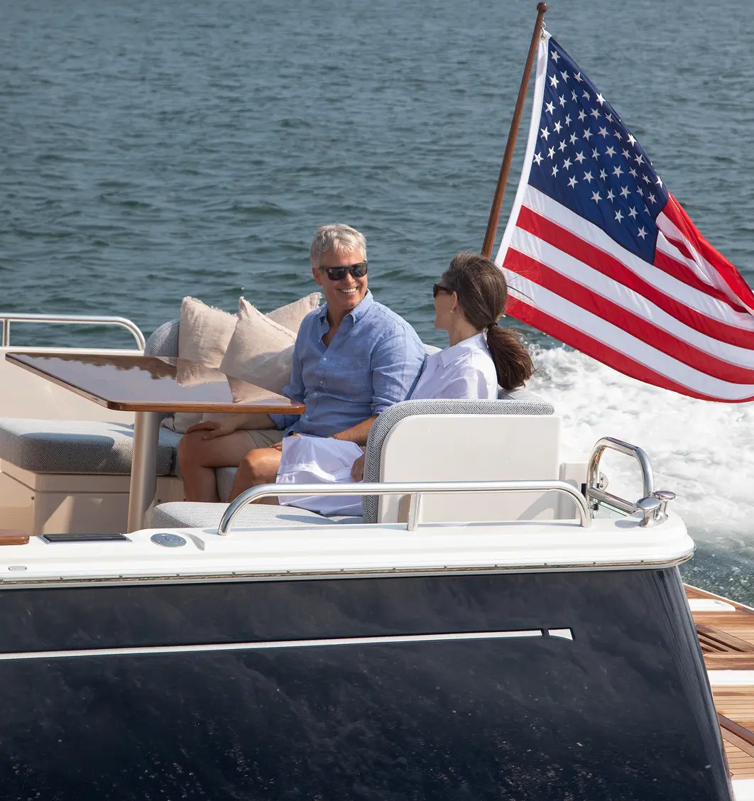 Couple enjoying a boat ride on custom yacht upholstery by Alfred’s, designed for comfort, durability, and style on the water.