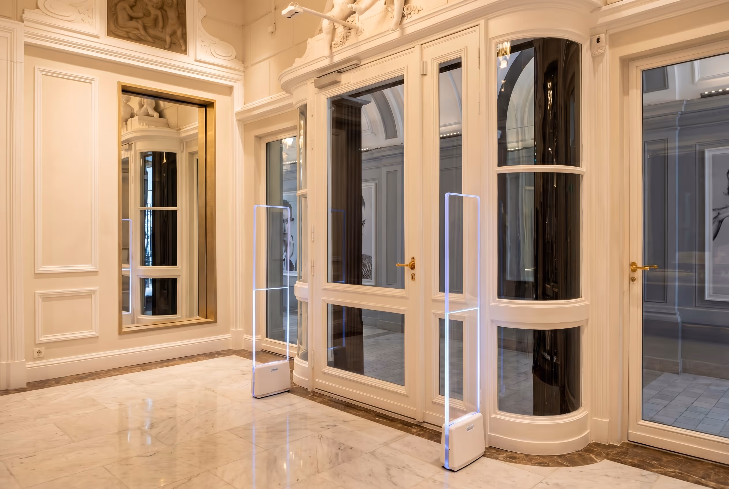 Luxury store interior displaying handbags, wallets, and high-heeled shoes on shelves with warm lighting.