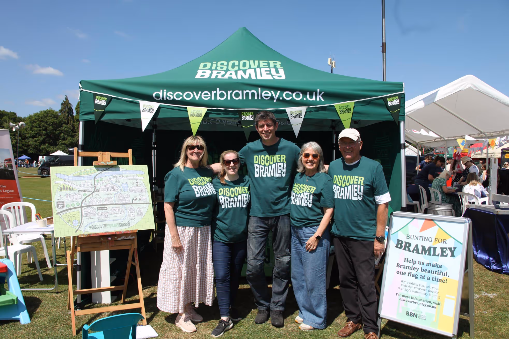 The Bramley Business Network team standing in front of a Discover Bramley tent