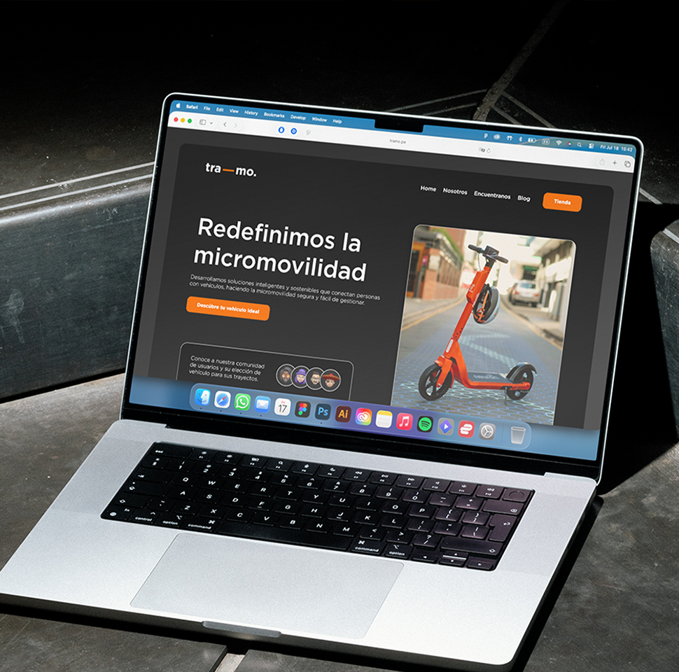 Laptop displaying a website homepage with a headline about redefining micromobility and an image of an orange electric scooter.