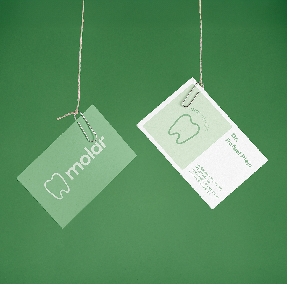 Two hanging business cards for Molar Studio with a tooth logo and contact details for Dr. Rafael Plejo on a green background.