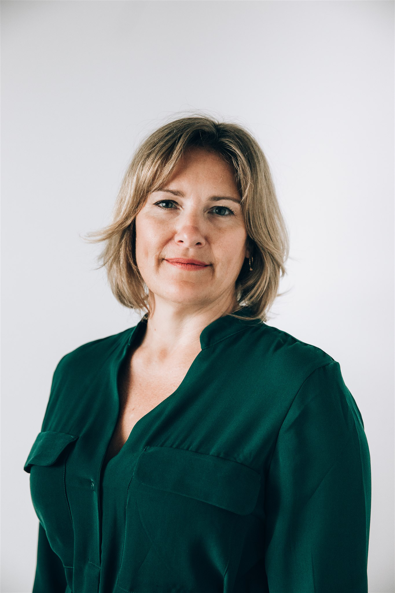 portrait of blonde woman in black blouse