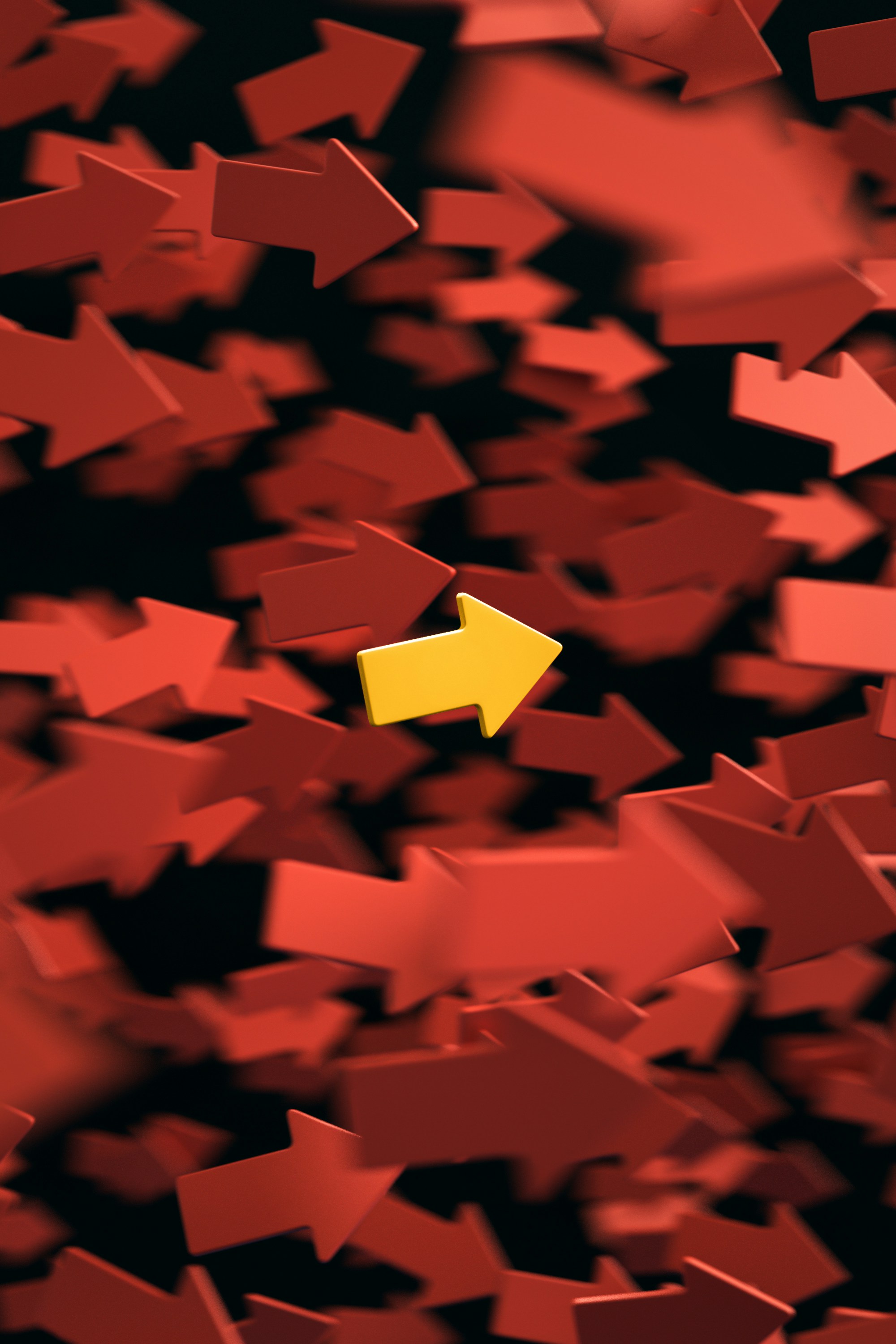 A yellow arrow stands out prominently among a group of red arrows, symbolizing uniqueness and distinction