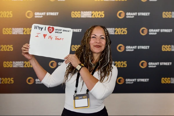 Team member holding a 'I love my team' sign.