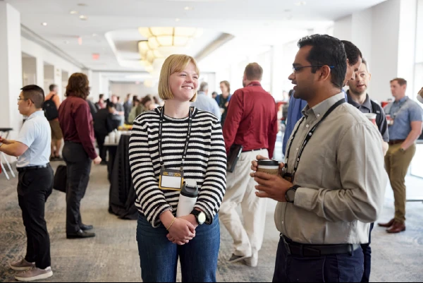 Team members catching up over coffee during a company event.