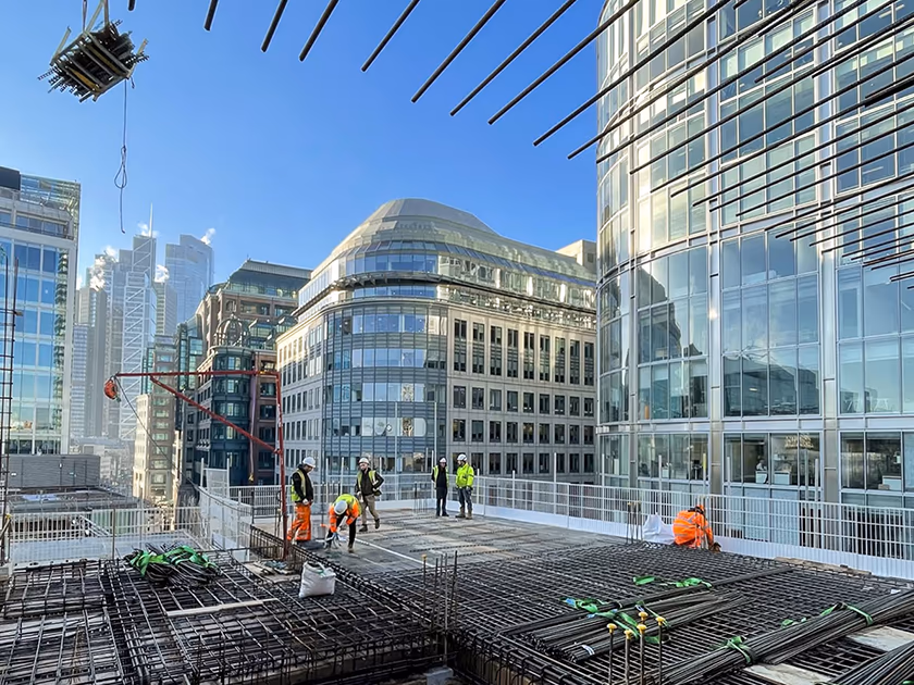 building project management at building site with construction workers