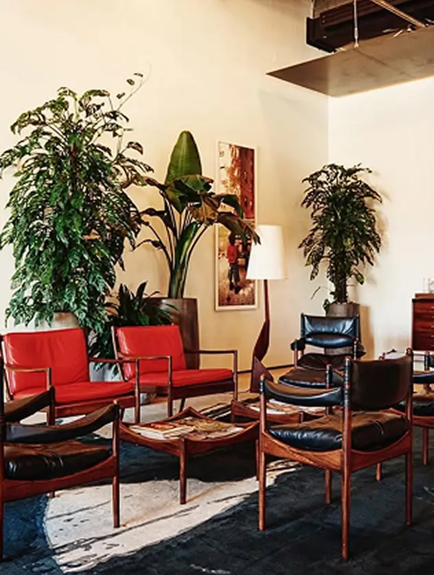 Red and black leather armchairs at Spring Place in a bold, modern lounge
