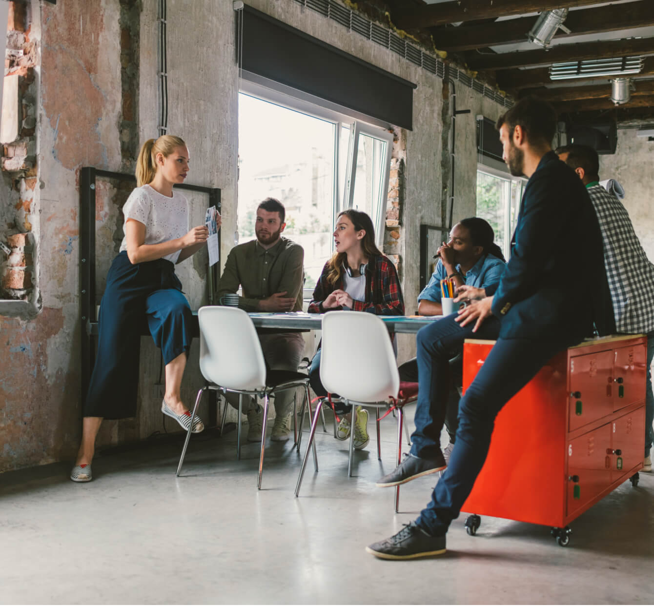 A team in a casual office setting has a meeting.
