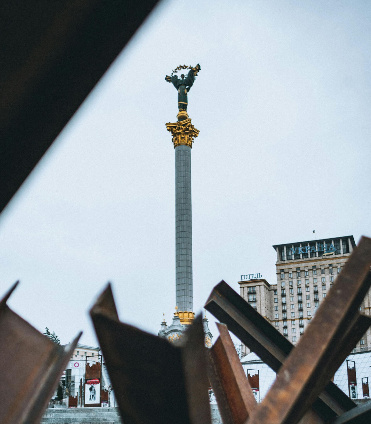 Independence Monument in Maidan Nezalezhnosti, Kyiv, Ukraine, seen through anti-tank barriers.