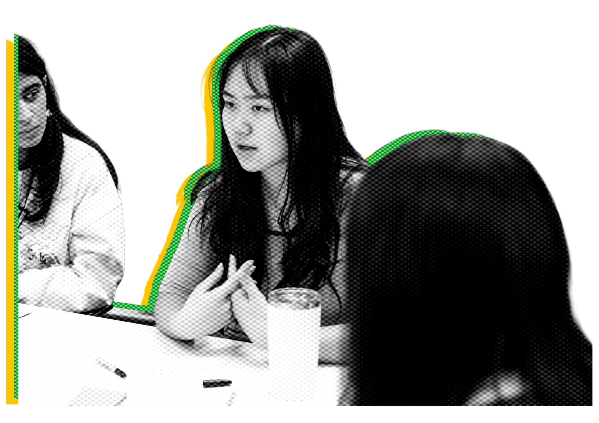 Three people in a serious discussion around a table with a glass of water and pens visible, one woman speaking and gesturing with her hands.
