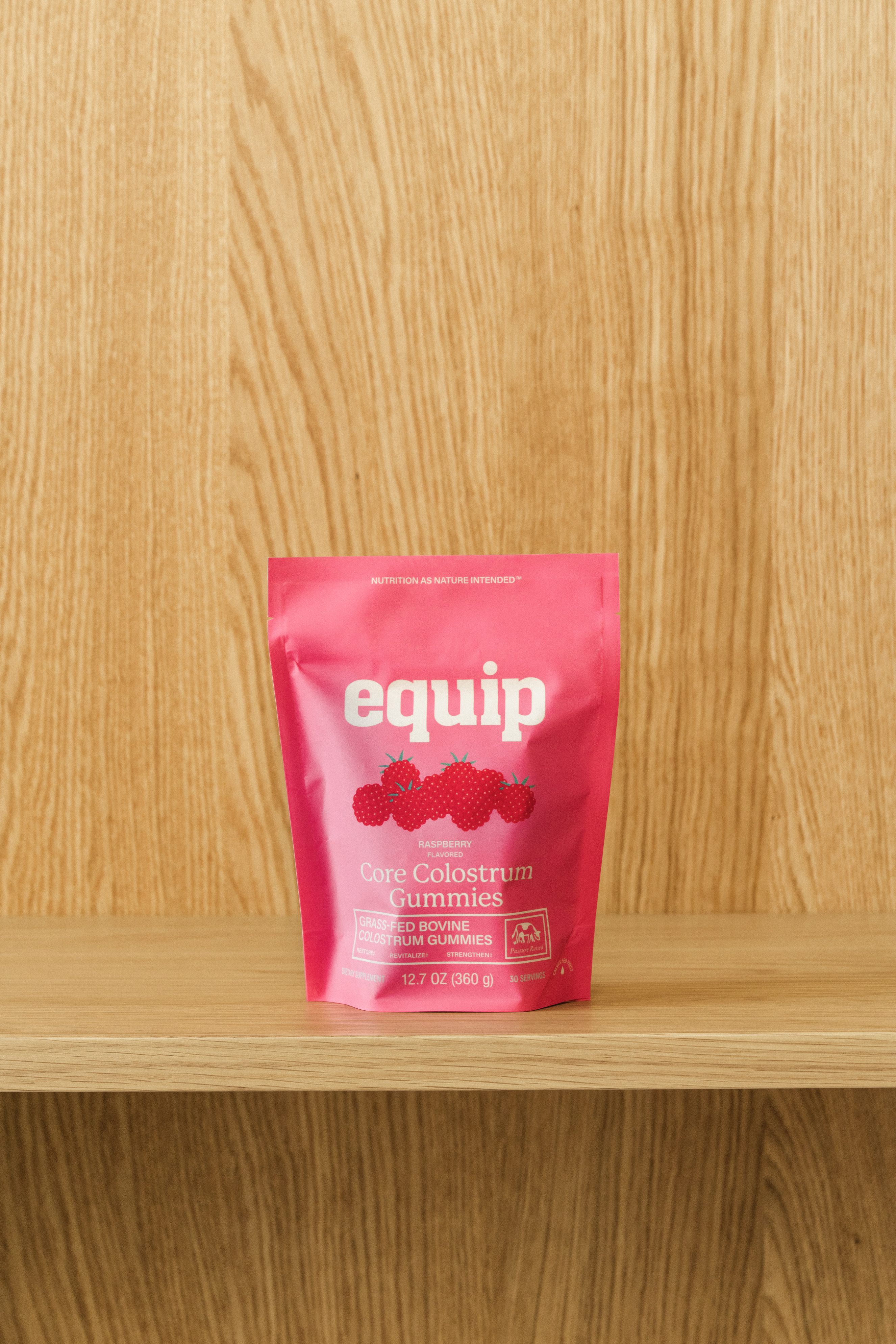 Colostrum gummies by "Equip" in a pink package.