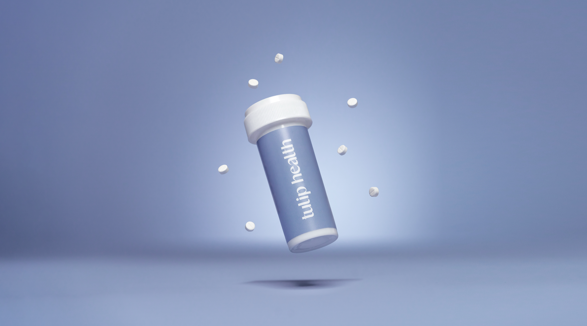 Tulip Health product photography with floating bottle and tablets