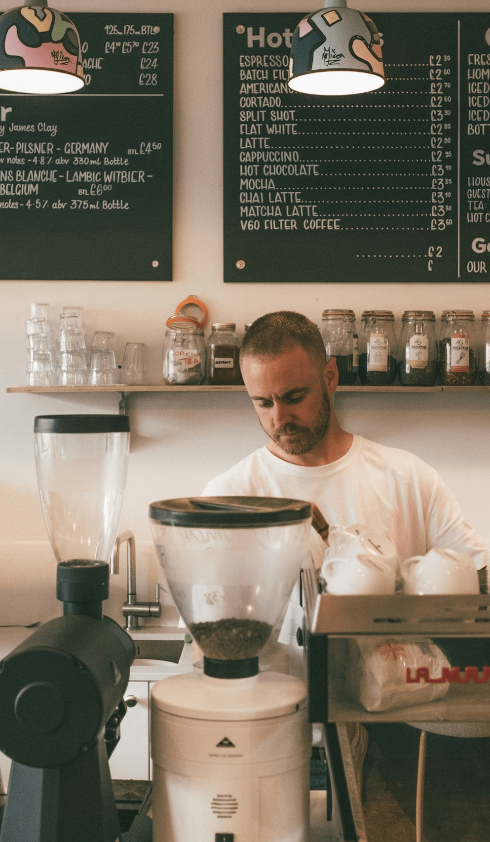 Independent barista making coffee in a neighborhood café, reflecting Worthify’s vision of supporting community businesses with branded loyalty solutions.