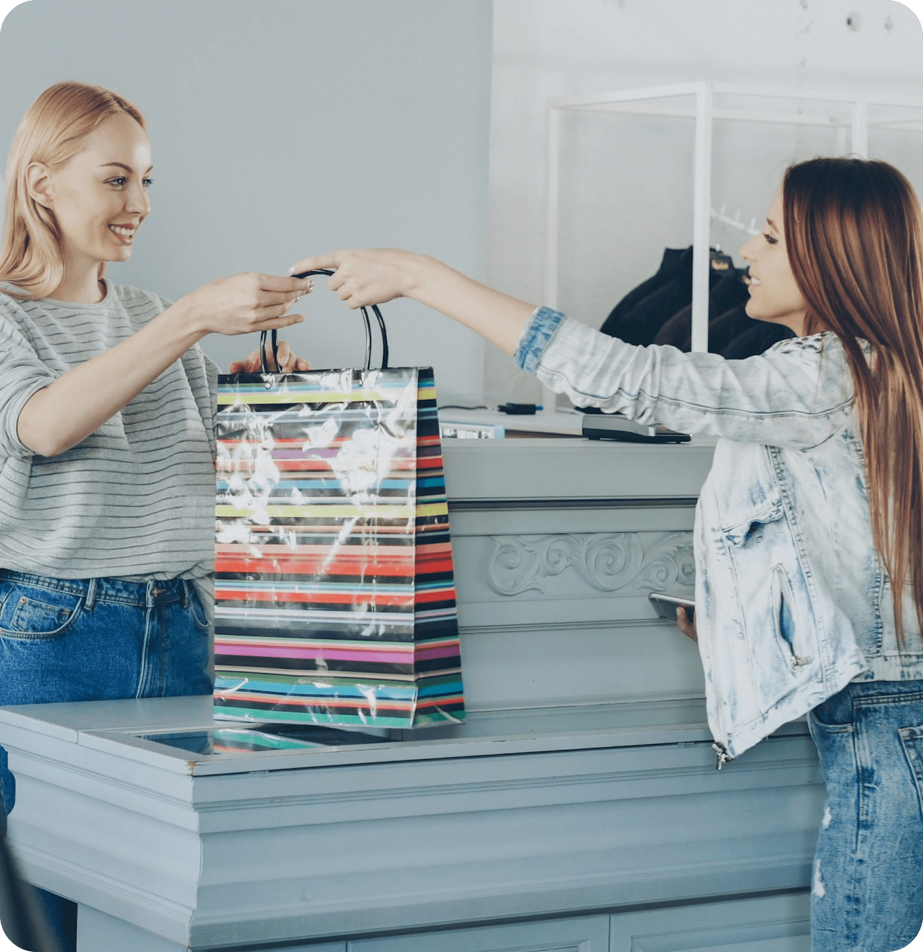 Independent boutique owner helping a customer with Worthify loyalty program encouraging repeat shopping.