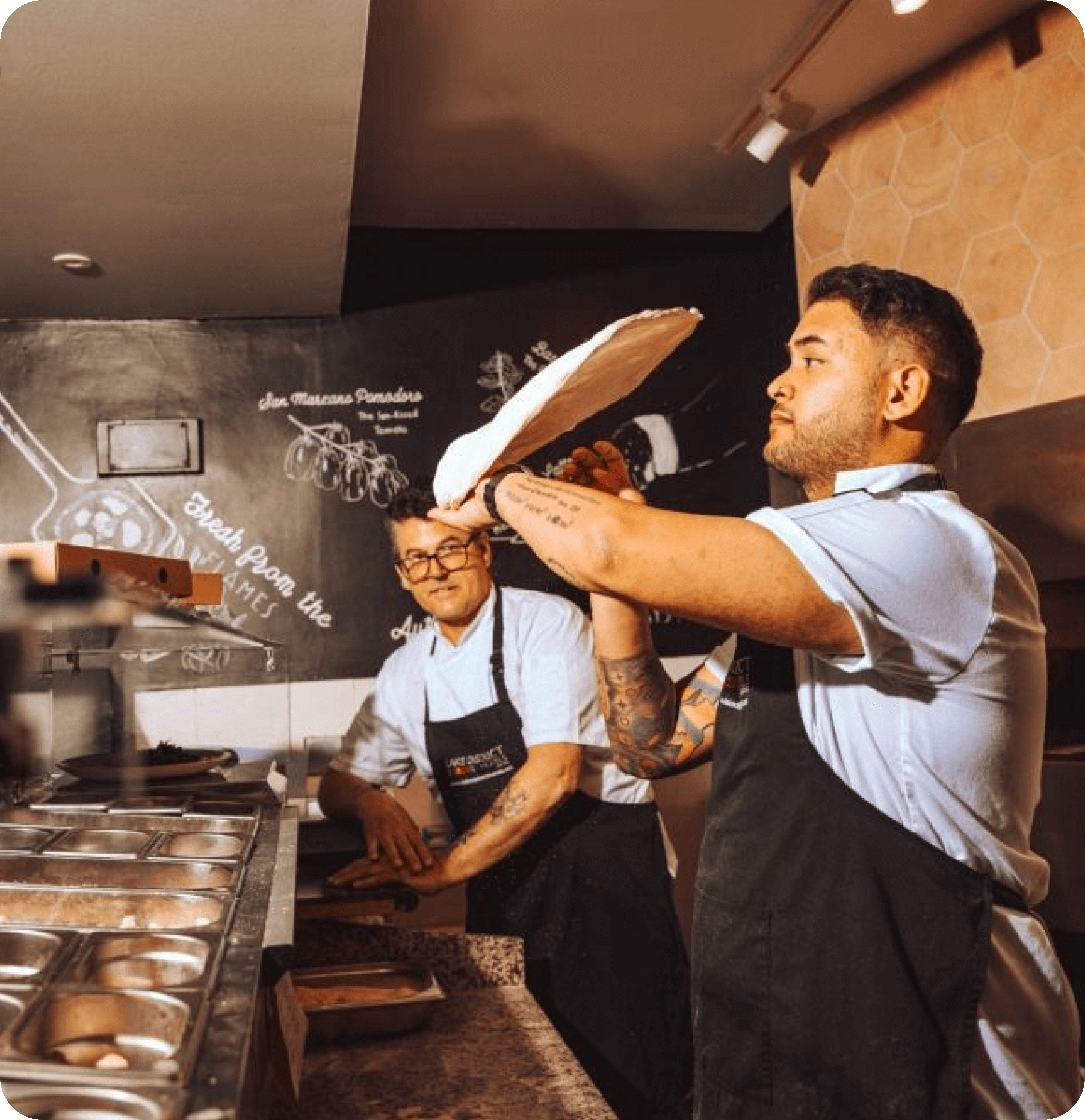 Independent pizzeria owner serving customers with Worthify loyalty program driving repeat pizza orders.