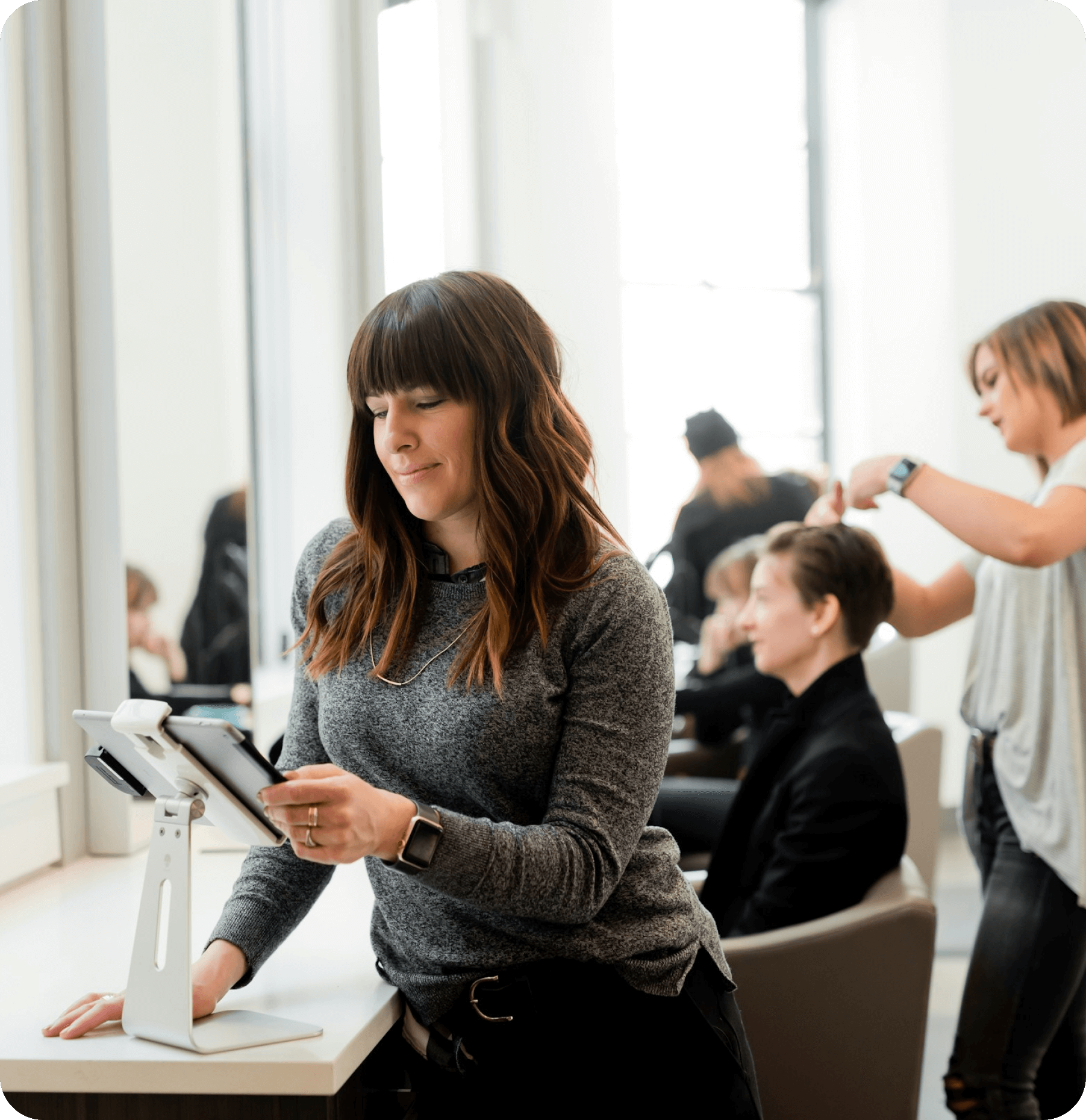 Salon owner styling a client’s hair with Worthify loyalty program encouraging repeat bookings.
