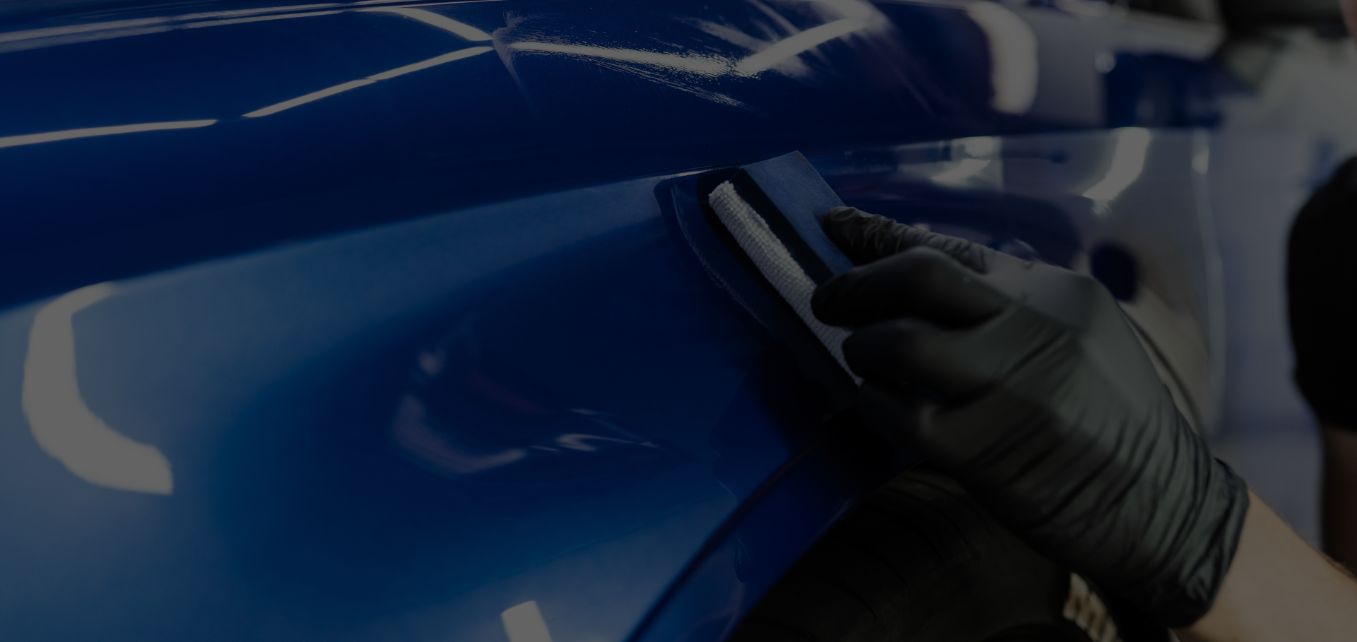 Technician finishing the surface of a fender.