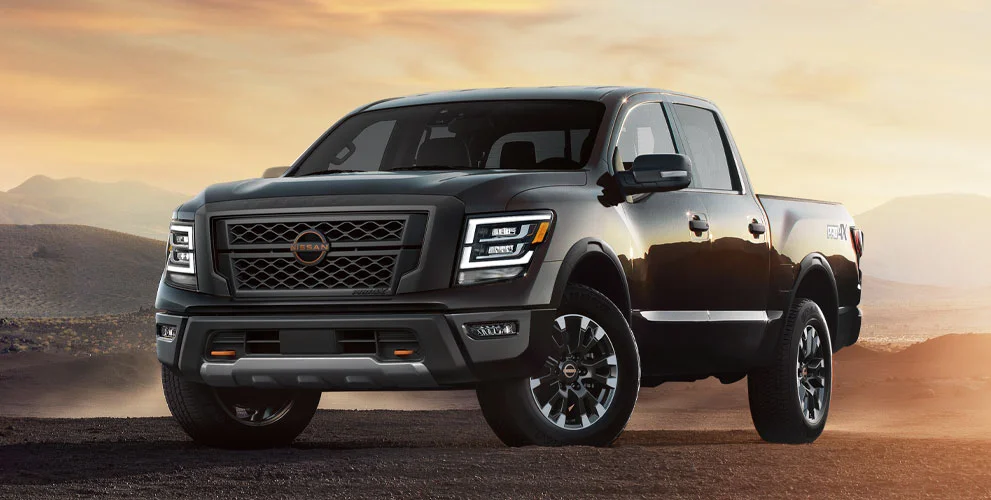 A Nissan pickup truck at sunset.