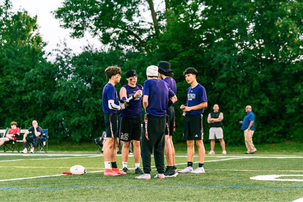 Flag football team huddle on the field