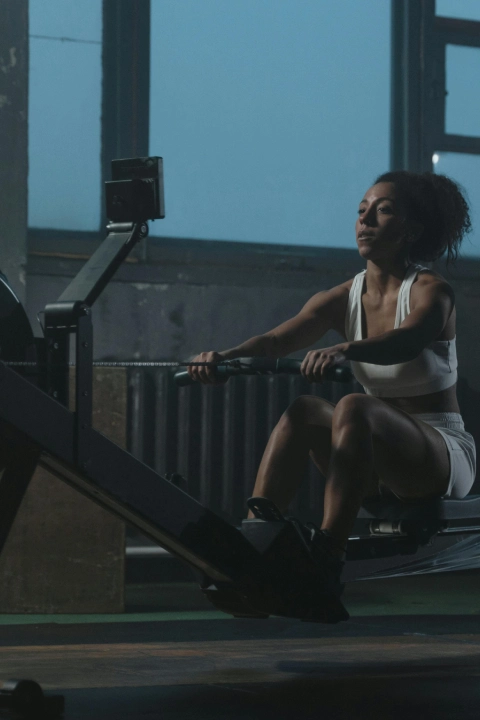 A woman rows on a rowing machine during a spin class at Strive Fitness in Lyons, IL.