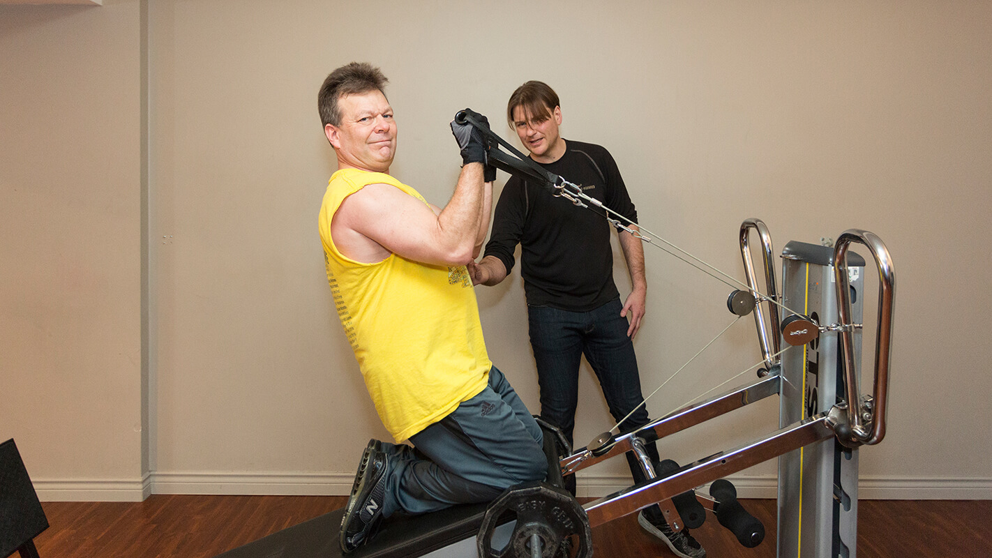 Person using a multi-functional Gravity Training system in a Vancouver studio, blending strength, cardio, and flexibility into one fluid movement