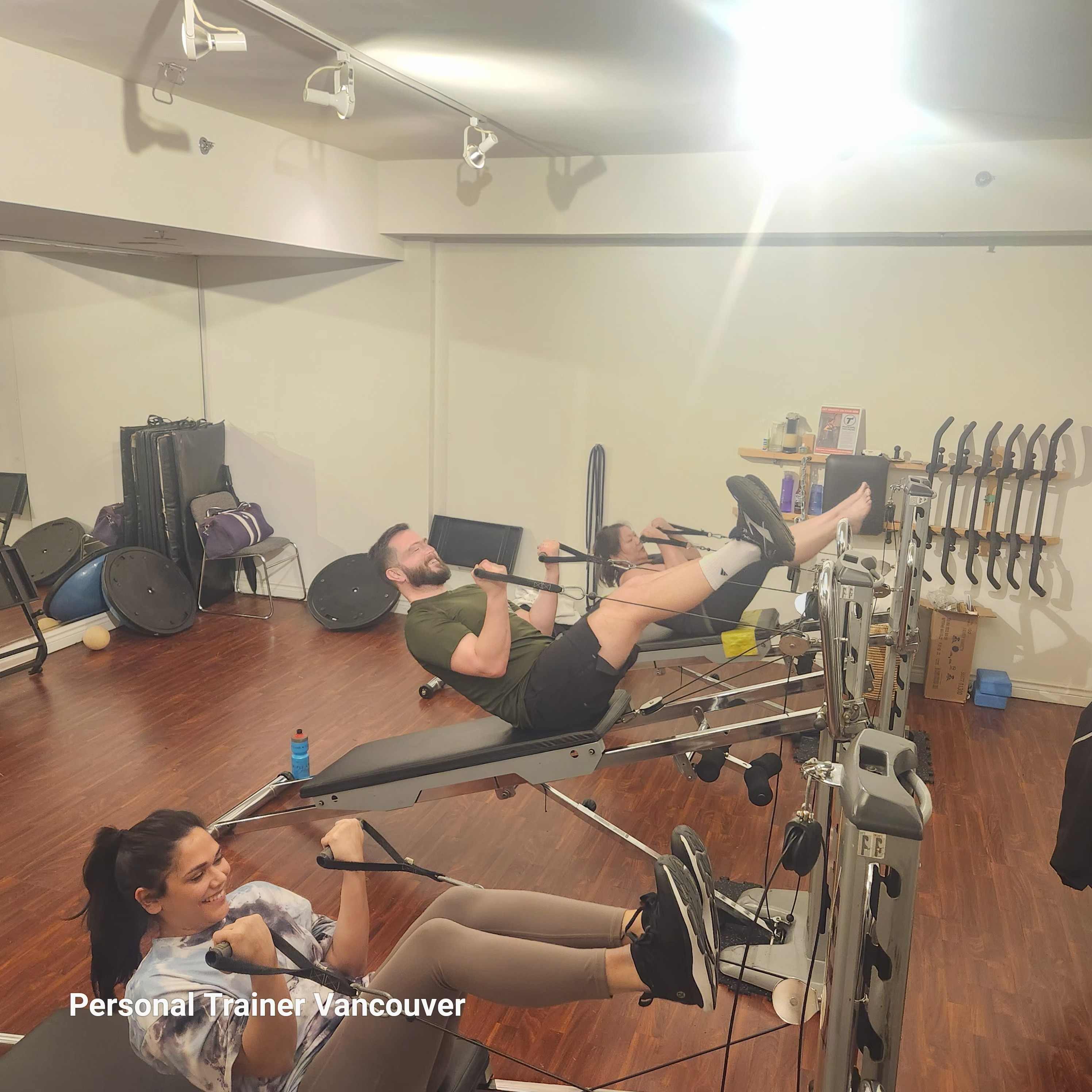 Personal trainer coaching busy professionals during strength and gravity training session in Downtown Vancouver private fitness studio