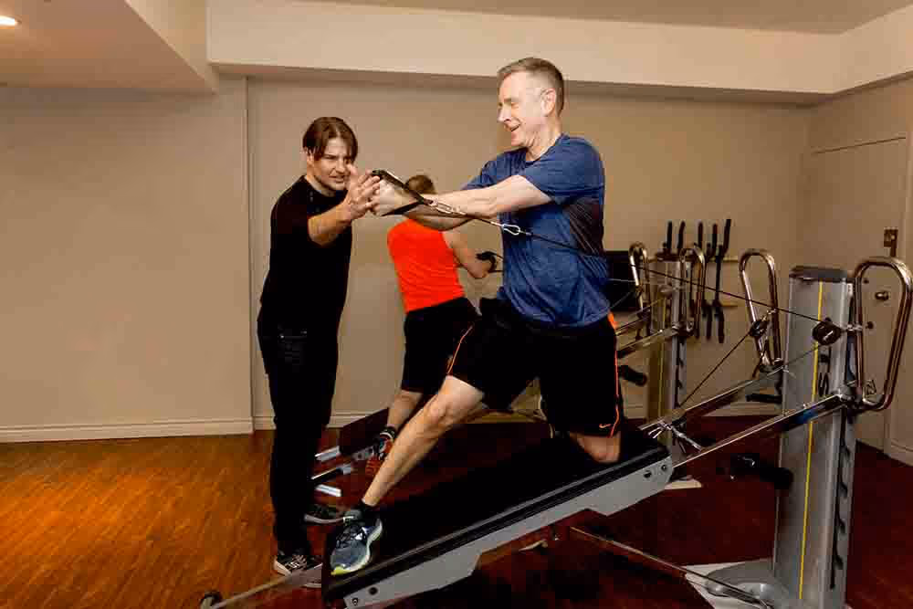 Vancouver personal trainer coaching a client through posture-correcting strength exercises