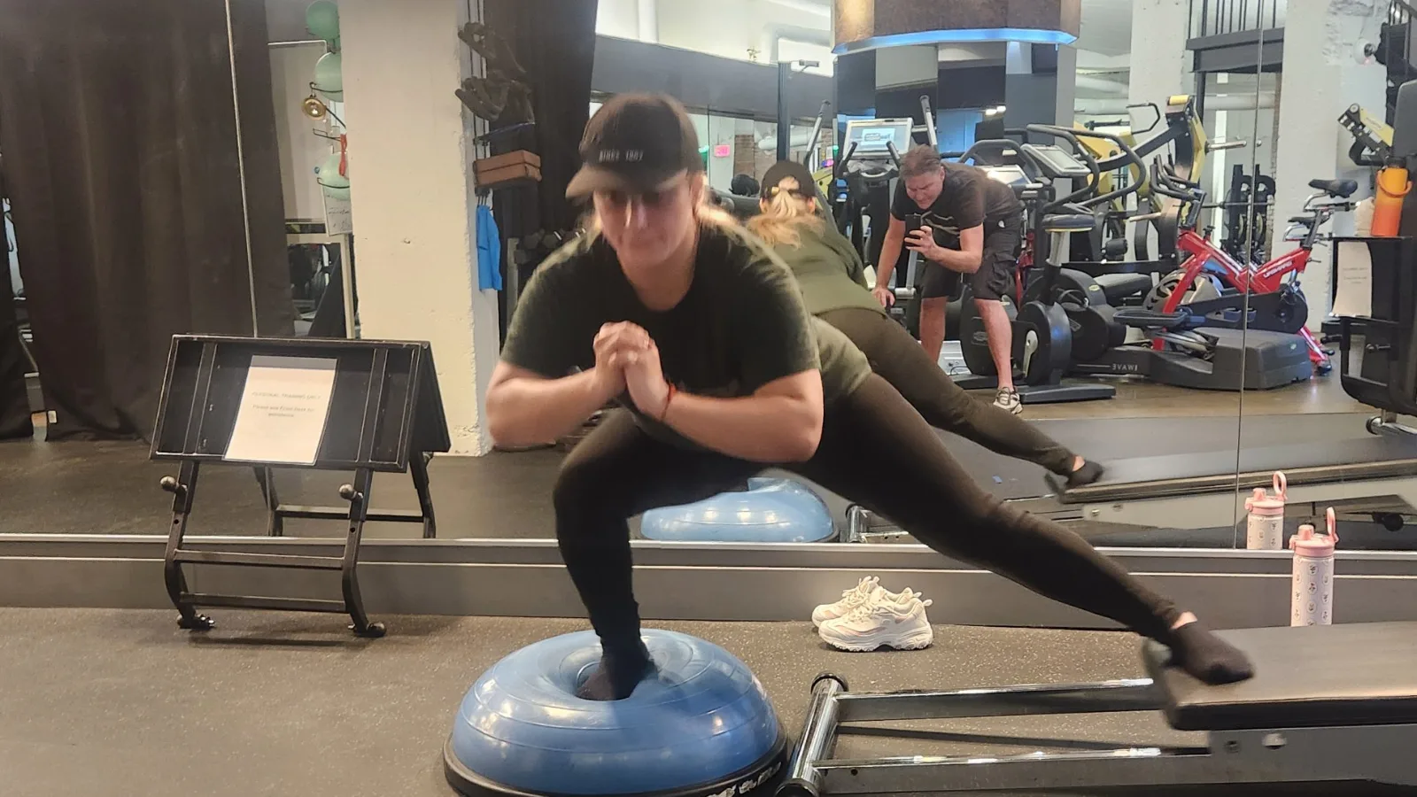 Client training balance and lateral strength on a BOSU and slide board at TSquared Personal Training in downtown Vancouver