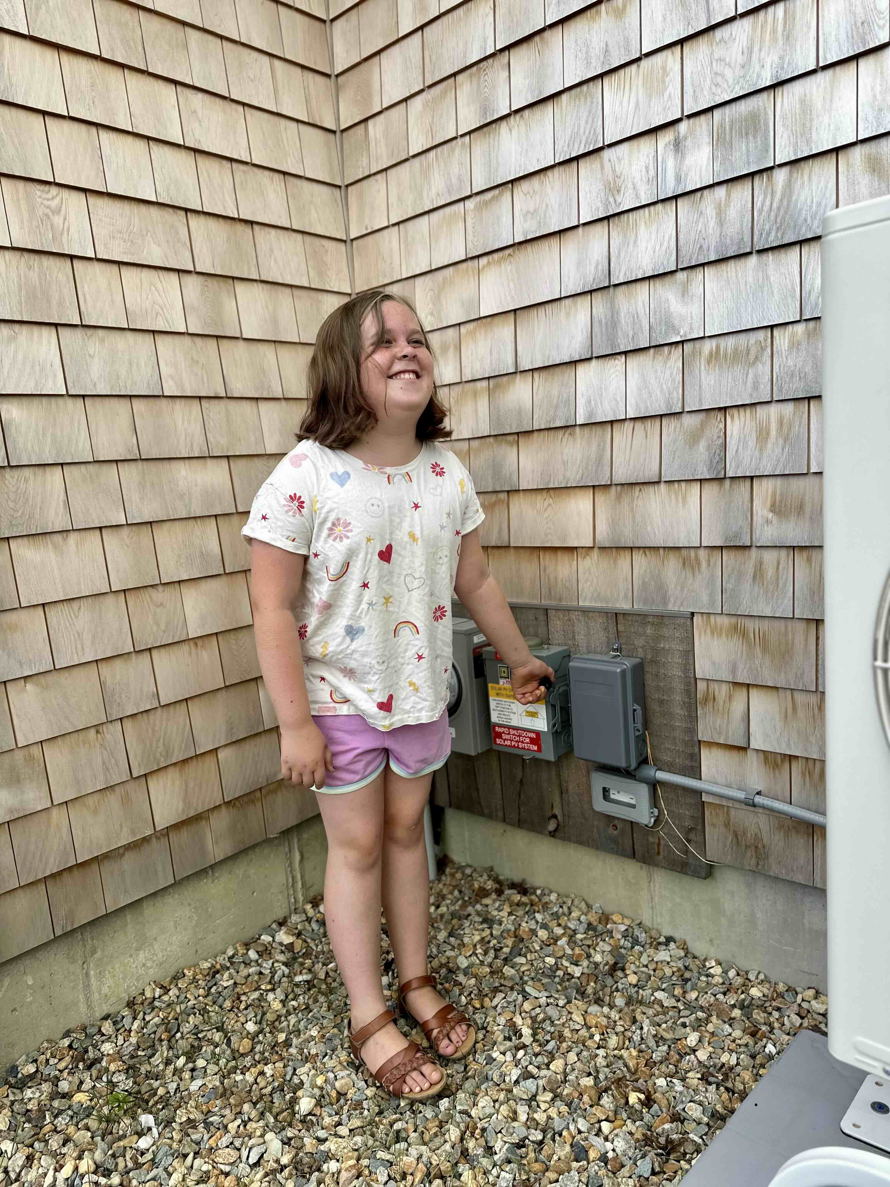 Young girl turning on a solar system.