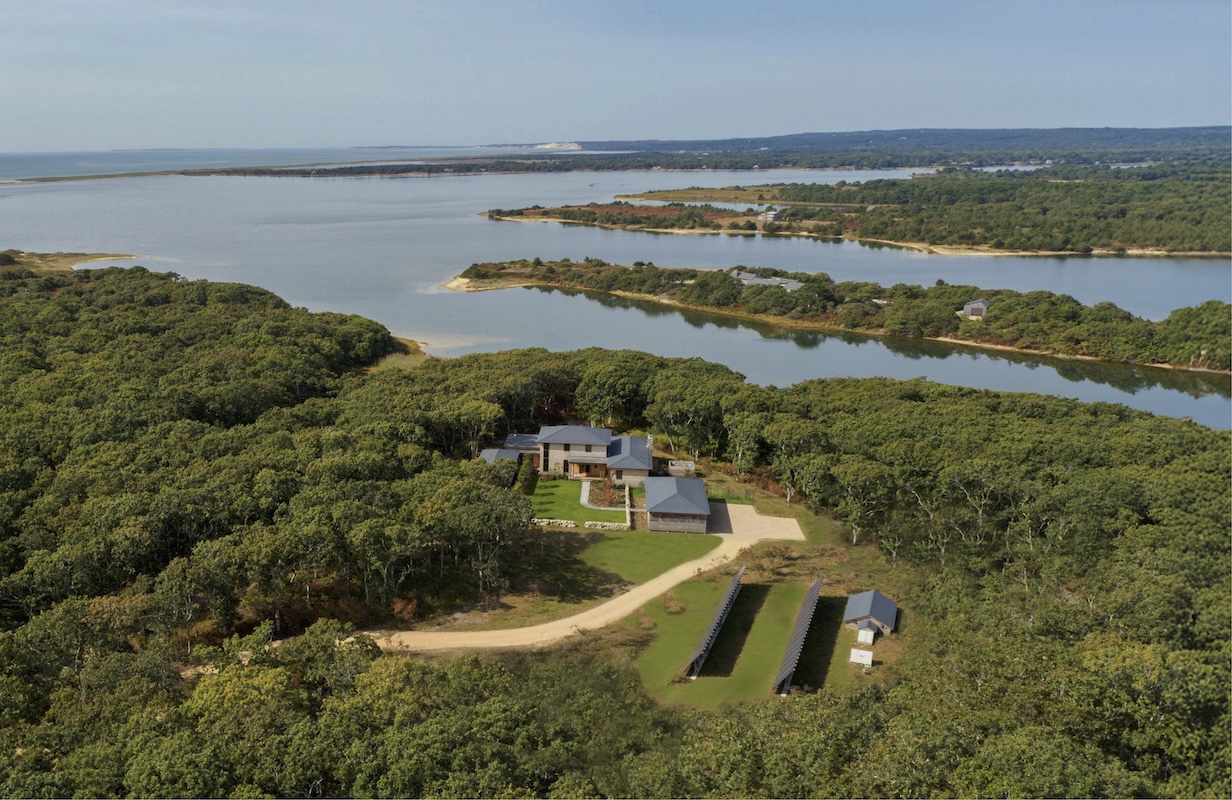 Aerial view of South Mountain Company house, carport and solar panels with a Tisbury Great Pond in the distance.