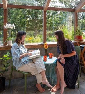 Having coffee and a chat in the sunroom in a South Mountain Company modern functional country home on Martha's Vineyard
