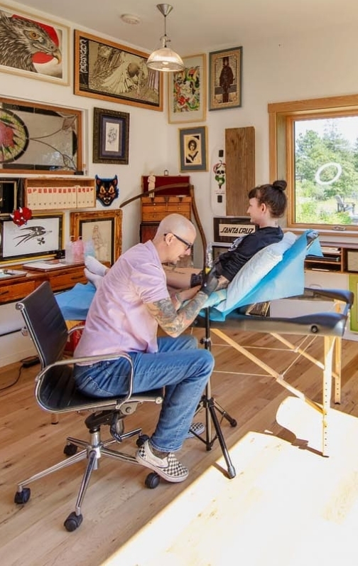 Seeing a client in the tatoo studio at a South Mountain Company modern functional country home on Martha's Vineyard
