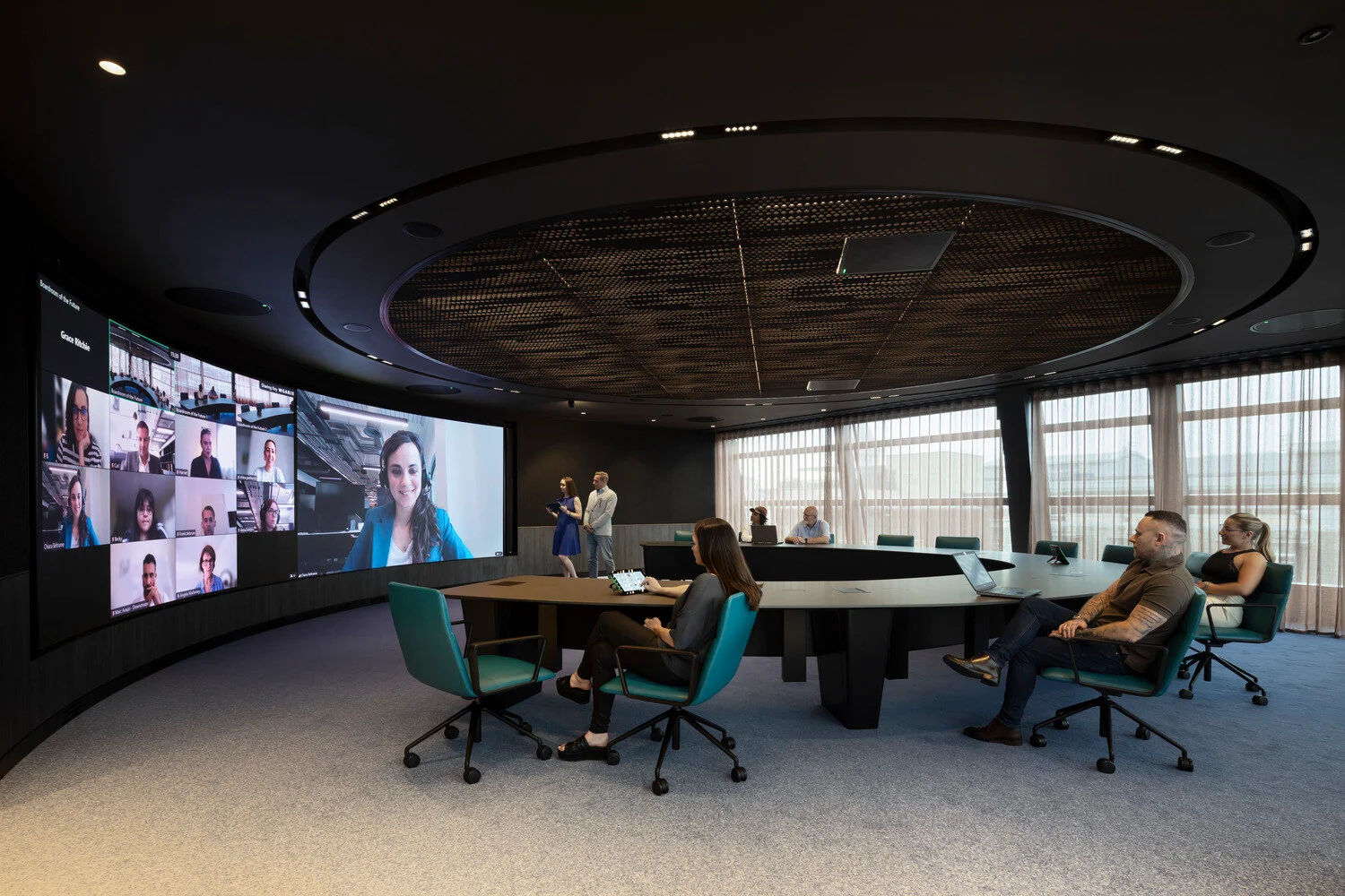 The 18-person boardroom features a floor-to-ceiling 8K LED screen. The latest camera and audio systems are integrated flawlessly into detailed timber-clad acoustic walls and a custom-feature ceiling. 