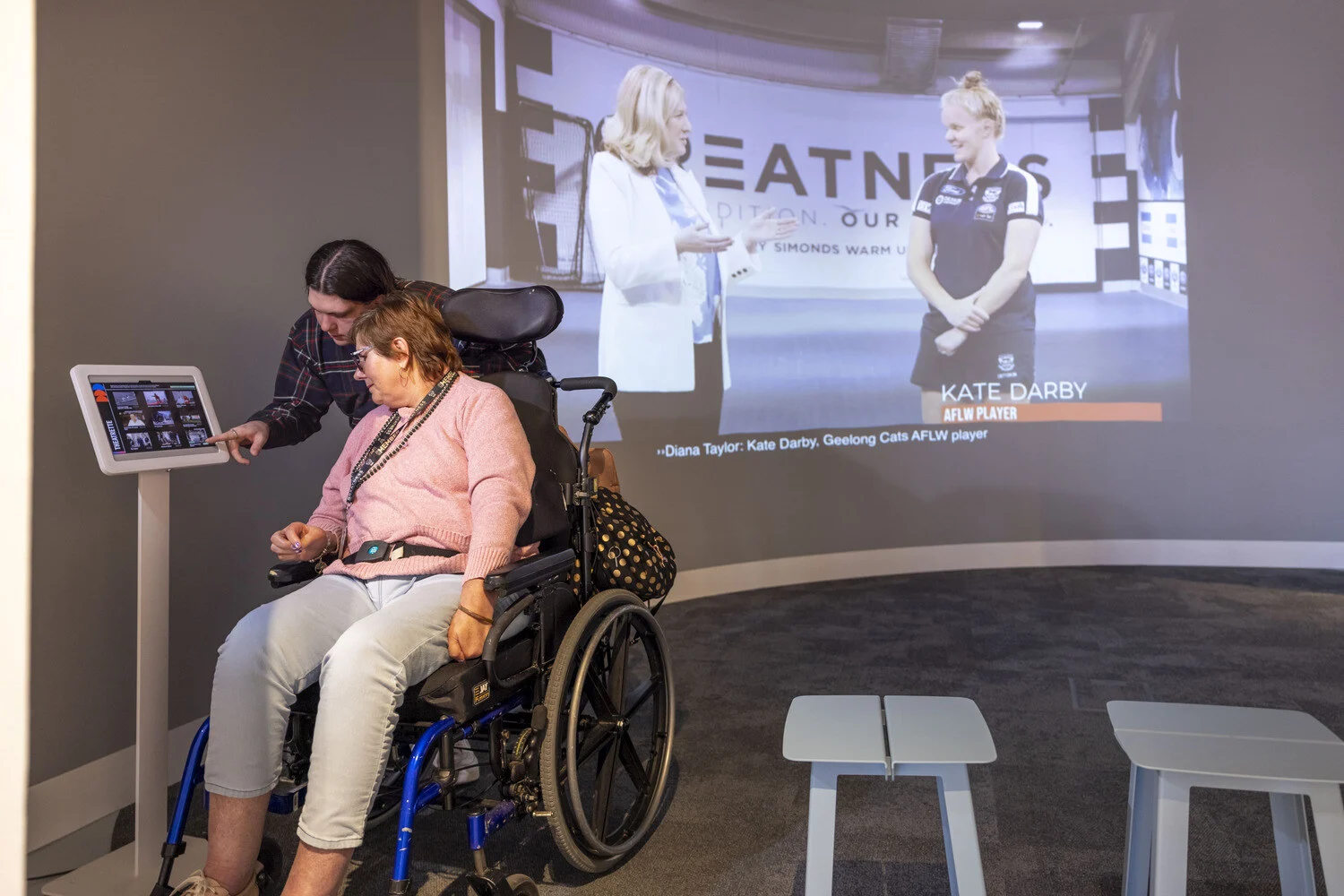 The theatrette is an informative and entertaining space, featuring a wide curved screen with a digital touchpad.